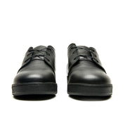 A pair of Broken Homme Ben Low black leather shoes with a cork filled midsole on a white background.