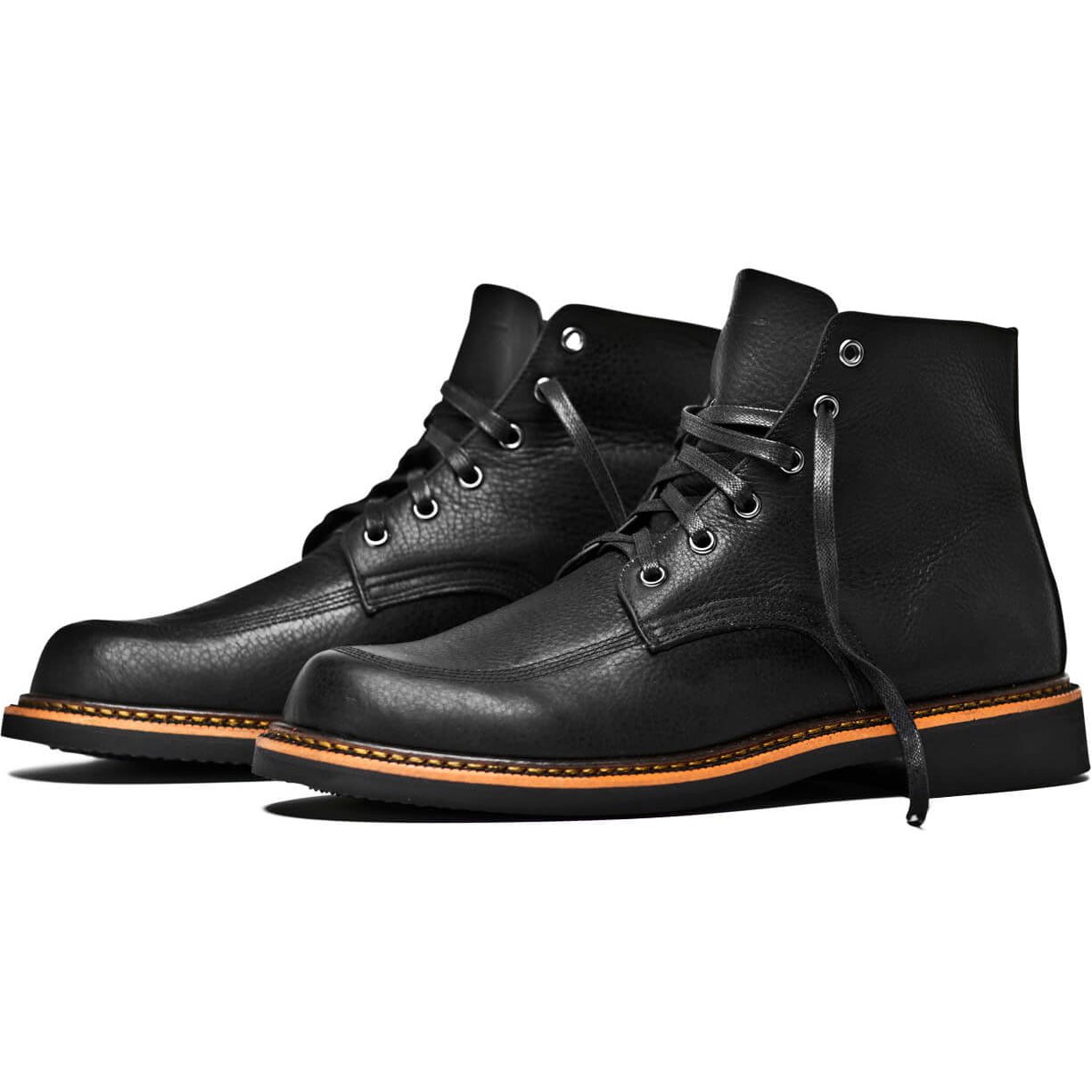 A pair of comfortable Davis black leather boots with orange soles from Broken Homme.