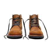 A pair of Davis boots by Broken Homme, made of brown leather with laces on a white background.