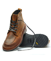 A pair of Davis II brown leather crossover boots by Broken Homme on a white background.