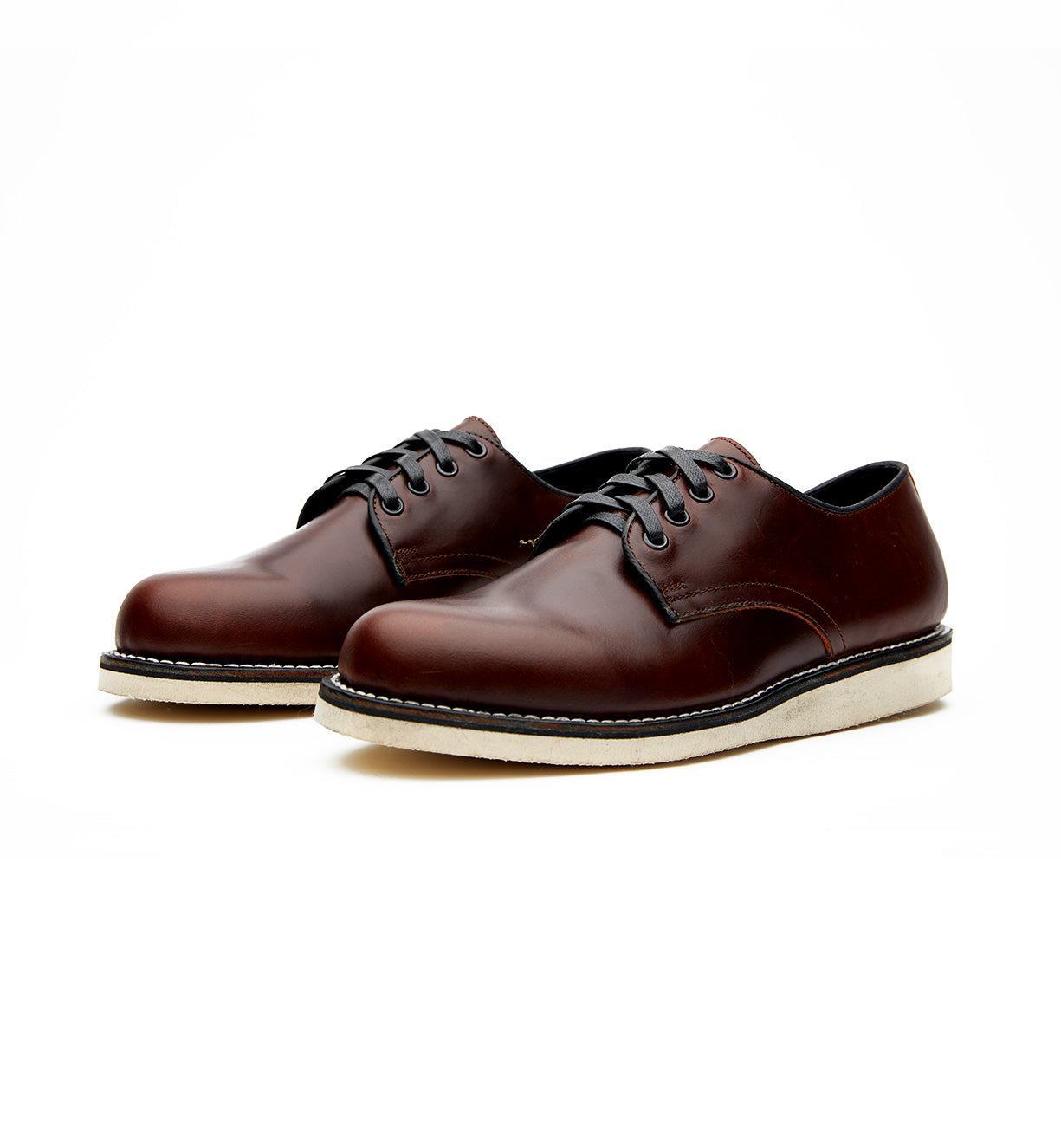 A pair of brown Michael II oxford shoes featuring a Vibram wedge outsole on a white background by Broken Homme.