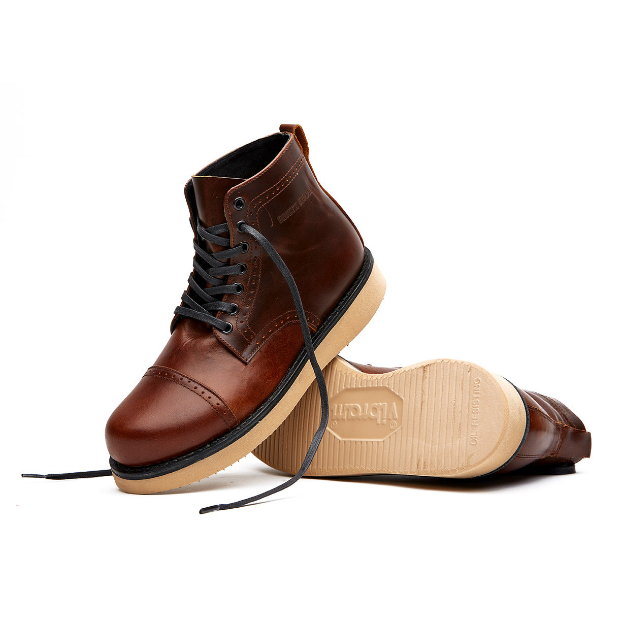 A pair of brown leather Broken Homme Shaun boots on a white background.
