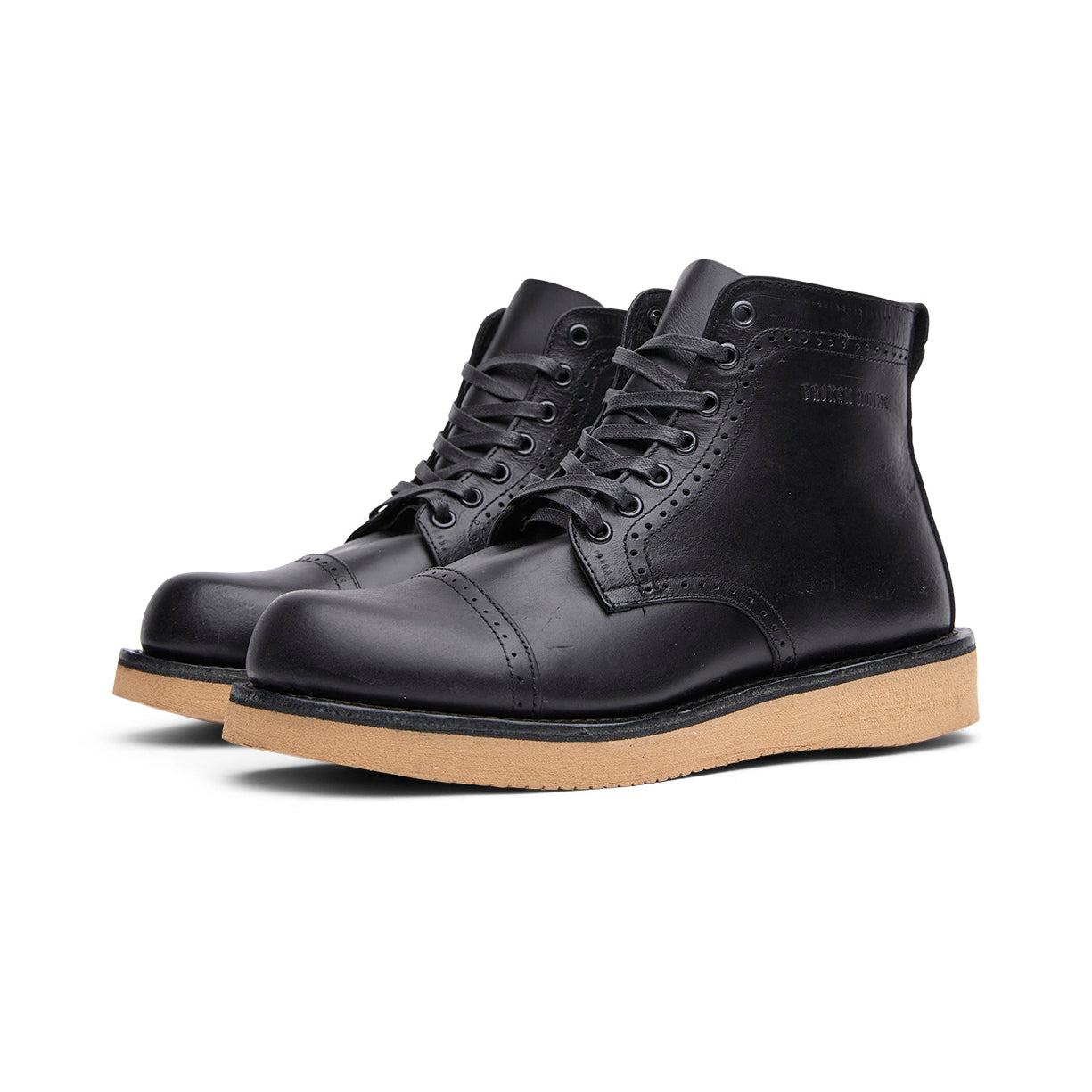 The Broken Homme Shaun boots feature a sleek black leather upper and are designed with a gum sole for excellent traction.