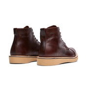 A pair of Shaun brown leather boots with a rubber sole from Broken Homme.
