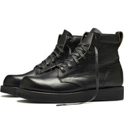 One of the signature James boots from the Broken Homme collection, a pair of black boots standing on a white background.