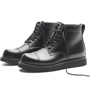 The Broken Homme Aaron Boot, a sleek and stylish addition to the Broken Homme collection, showcases a cap toe silhouette. These black boots stand out on a crisp white background.