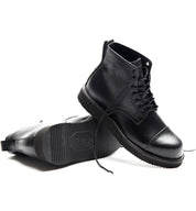 The Broken Homme collection features the sleek and stylish Broken Homme Aaron Boot, a black leather pair that effortlessly stands out on a crisp white background. With its cap toe silhouette, this boot is both sophisticated.