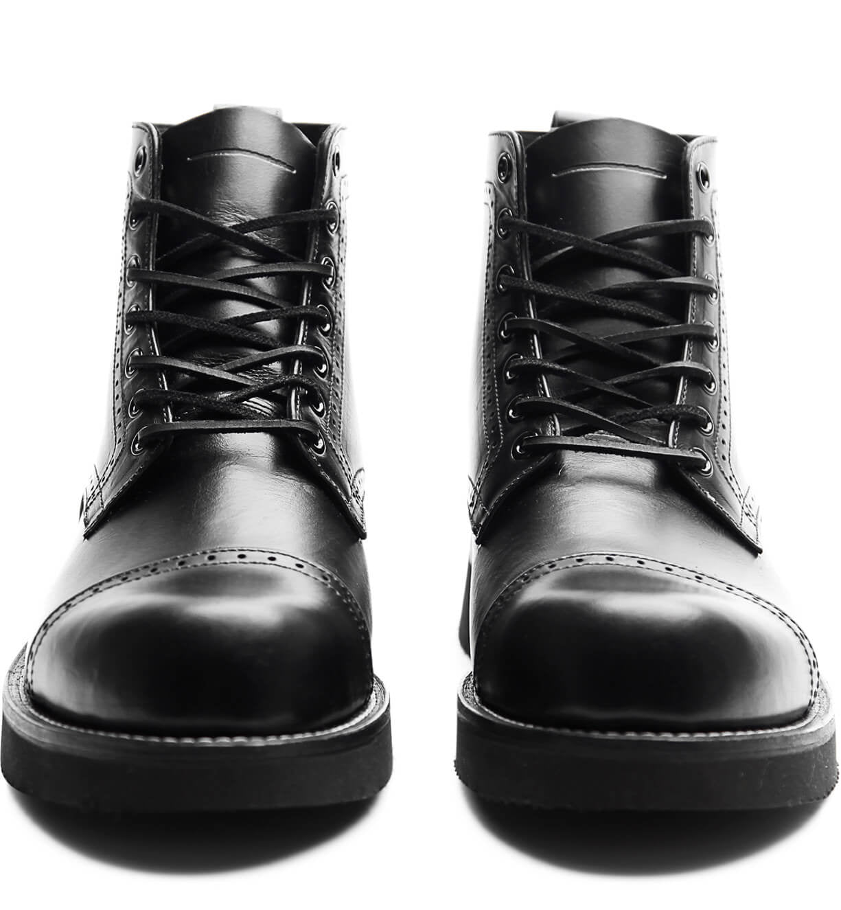 A pair of black leather Aaron boots from the Broken Homme collection, featuring a cap toe silhouette, photographed on a clean white background.