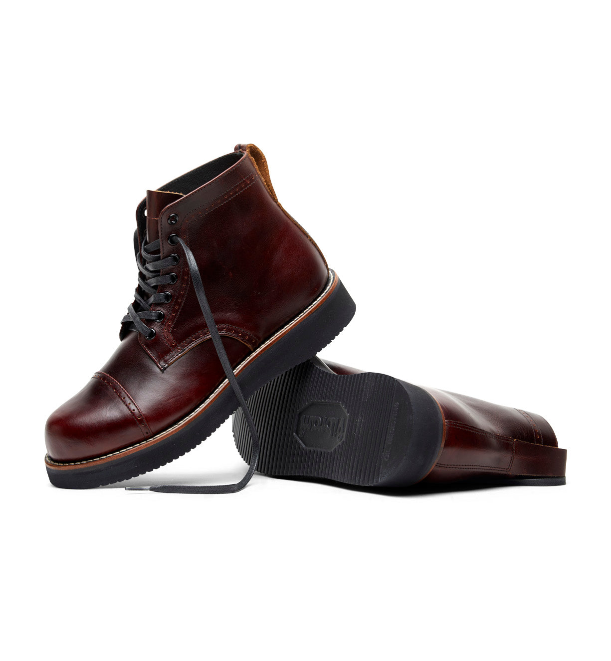The Broken Homme Aaron Boot, a classic cap toe silhouette, in burgundy leather.