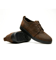A pair of Broken Homme Ben Low men's brown sneakers on a white background.