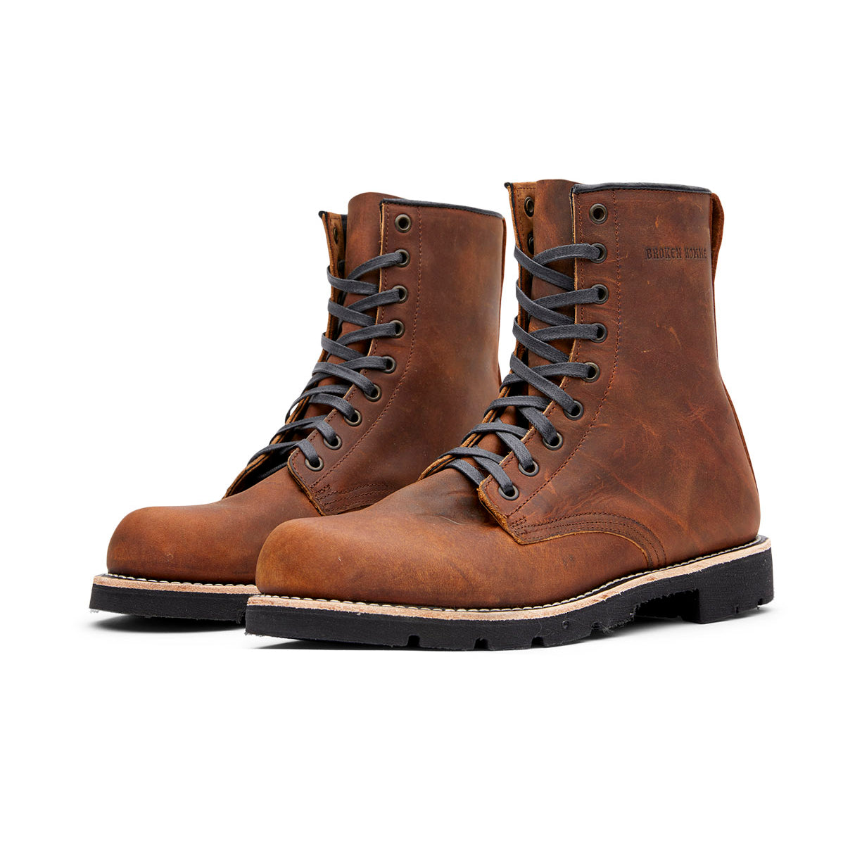 A pair of Broken Homme Jacob men's brown boots on a white background, crafted with 360 full grain leather welt.