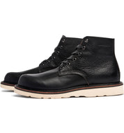 A black leather Jaime Boot by Broken Homme with a white sole.