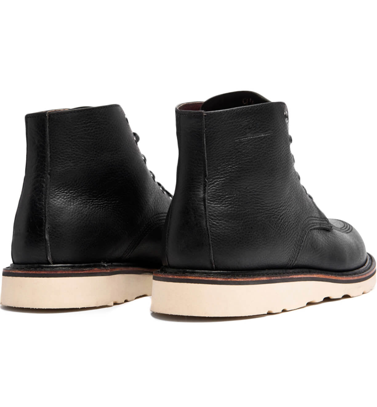 A pair of Broken Homme Jaime Boots, black leather boots with a natural wedge on a white background.