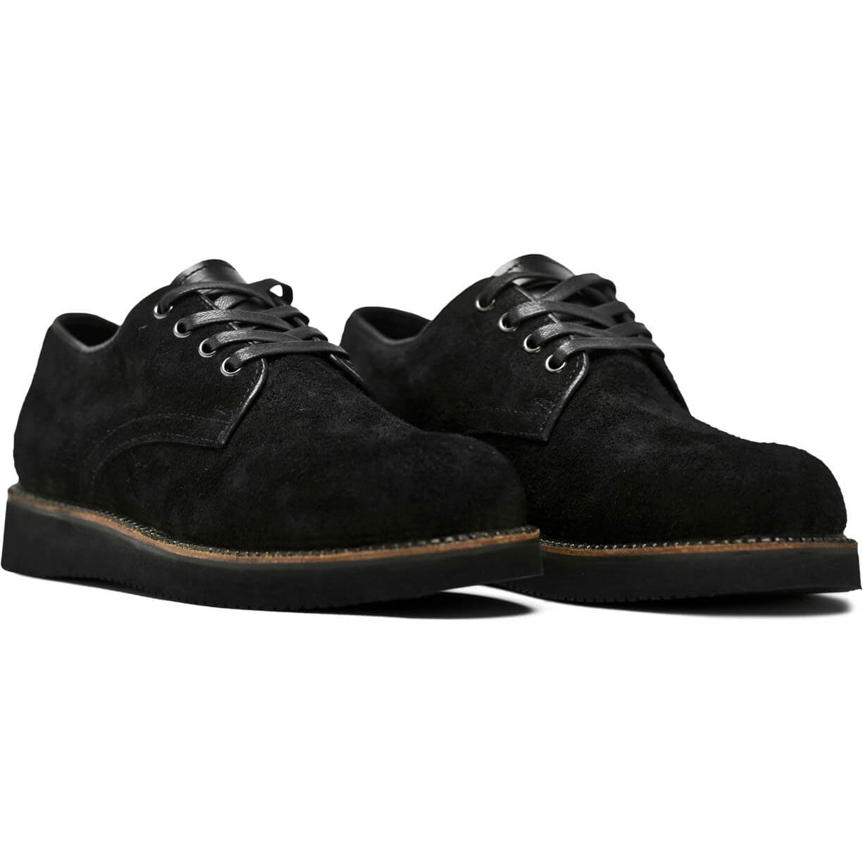 A pair of Broken Homme Michael II black suede shoes featuring pinpoint construction details and an oxford silhouette, showcased against a pristine white background.