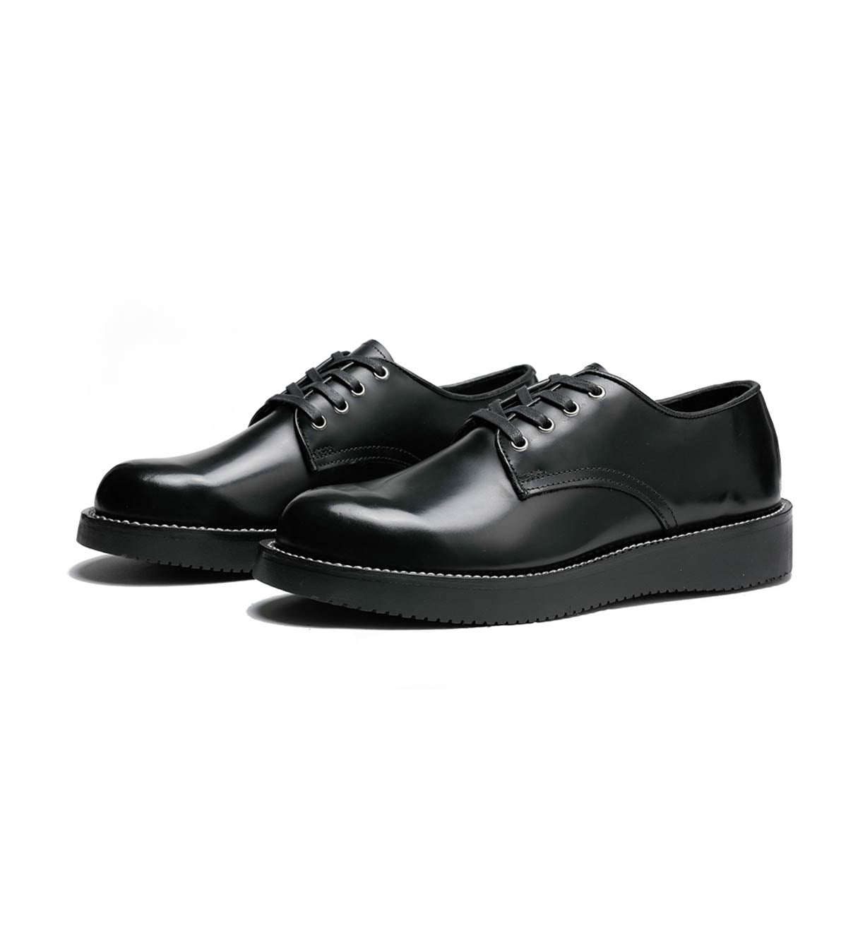 A pair of black Michael derby shoes by Broken Homme with leather uppers and a vibram wedge outsole on a white background.