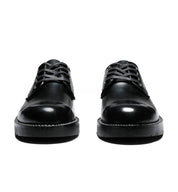 A pair of Broken Homme Michael black leather shoes on a white background featuring leather uppers and an oxford silhouette.