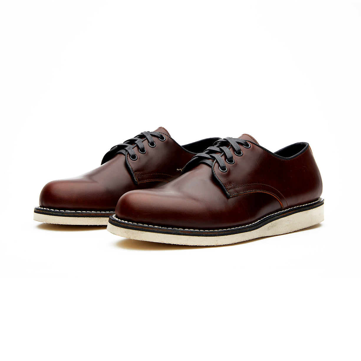 A pair of brown Michael II oxford shoes featuring a Vibram wedge outsole on a white background by Broken Homme.