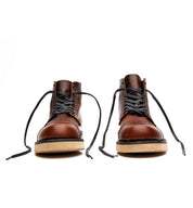 A pair of brown leather Broken Homme Shaun boots with a leather upper and goodyear welt on a white background.