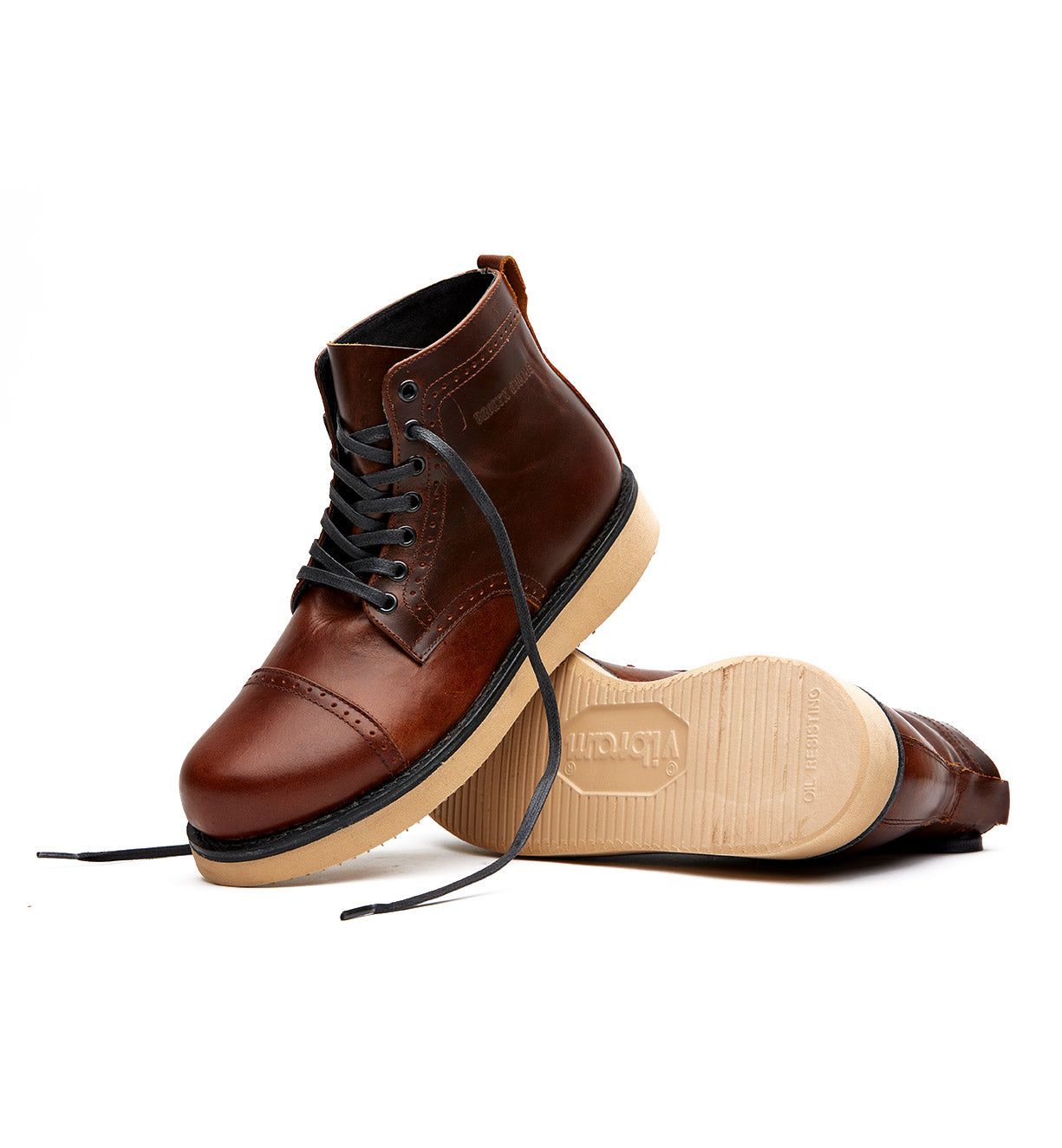 A pair of brown leather Broken Homme Shaun boots on a white background.