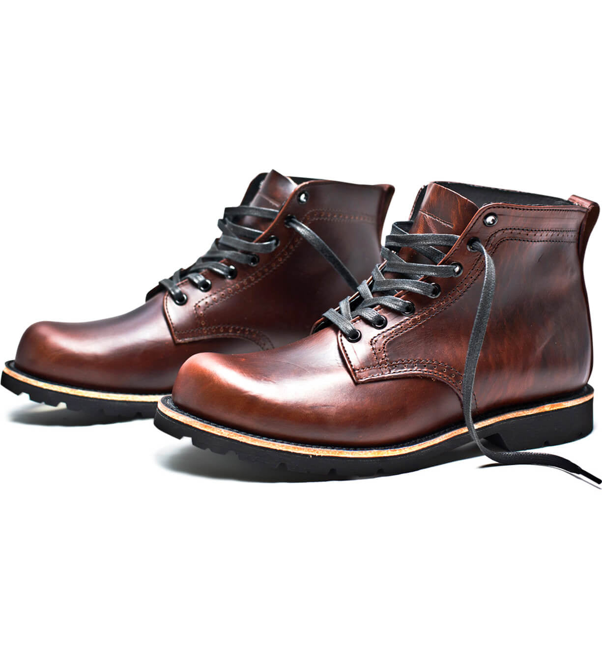 A pair of Tydus boots by Broken Homme with a rugged outsole on a white background.