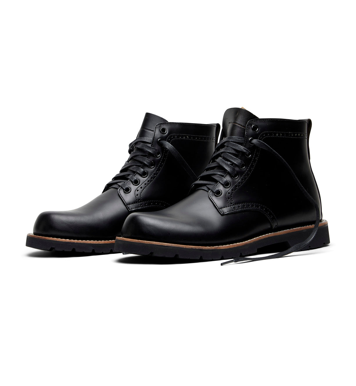 A pair of Broken Homme Tydus full grain leather boots on a white background with a refined style.