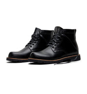 A pair of Tydus black leather boots by Broken Homme with a refined style on a white background.
