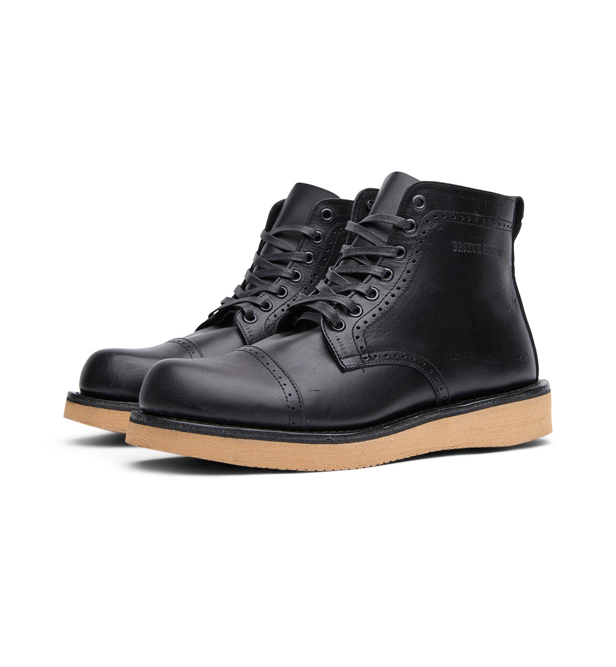 The Broken Homme Shaun boots feature a sleek black leather upper and are designed with a gum sole for excellent traction.