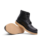 A pair of black leather Broken Homme Shaun boots on a white background.
