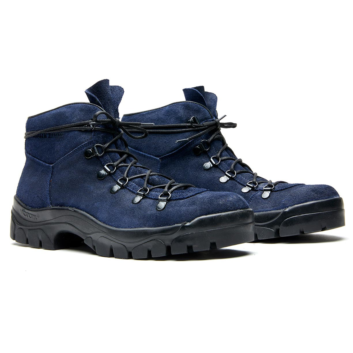 A pair of Weber hiking boots with a crossover boot design by Broken Homme on a white background.